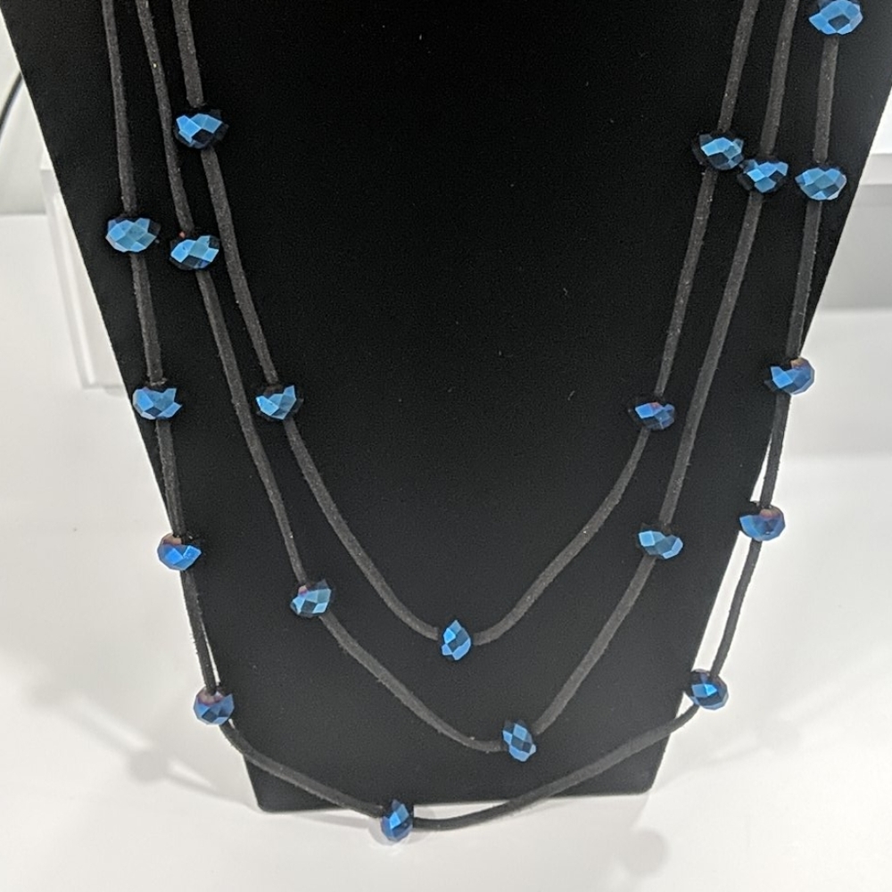 Blue beads on a multi-strand black cord necklace